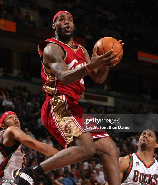 LeBron James of the Cleveland Cavaliers moves to the basket past Mo Williams and Charlie Bell of the Milwaukee Bucks on February 26, 2008 at the...