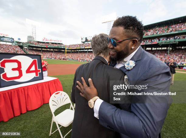 David Ortiz hugs Boston Red Sox owner John Henry during a number retirement ceremony at Fenway Park on June 23, 2017 in Boston, Massachusetts.