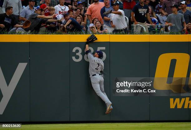 Nick Franklin of the Milwaukee Brewers attempts to catch a solo homer hit by Brandon Phillips of the Atlanta Braves in the first inning at SunTrust...