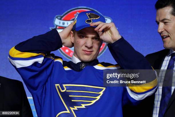 Robert Thomas puts on the St. Louis Blues hat after being selected 20th overall during the 2017 NHL Draft at the United Center on June 23, 2017 in...