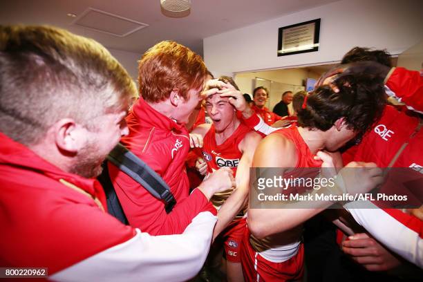 Will Hayward of the Swans celebrates with players and staff after victory in the round 14 AFL match between the Sydney Swans and the Essendon Bombers...