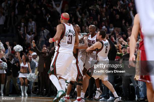 Charlie Villanueva, Charlie Bell, Michael Redd and Andrew Bogut of the Milwaukee Bucks celebrate following Redd's game-winning three-point shot at...