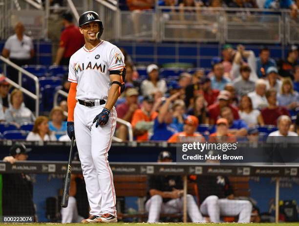 Giancarlo Stanton of the Miami Marlins smiles in the eighth during the game between the Miami Marlins and the Chicago Cubs at Marlins Park on June...