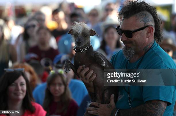 Jon Adler of Davis, California, holds his mixed breed dog named Icky during the 2017 World's Ugliest Dog contest at the Sonoma-Marin Fair on June 23,...