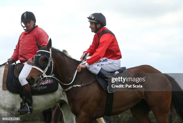 Damien Oliver returns to the mounting yard on Encosta Line after winning Grampians Region Handicap,at Flemington Racecourse on June 24, 2017 in...