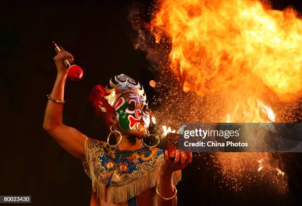 Sichuan Opera actor performs fire breathing during a show of traditional operas at the Mei Lanfang Grand Theatre on February 26, 2008 in Beijing,...