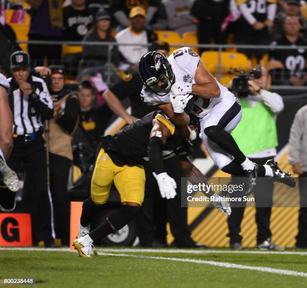 Baltimore Ravens running back Michael Campanaro, right, dives for the end zone on an 11-yard touchdown run against the Pittsburgh Steelers at Heinz...