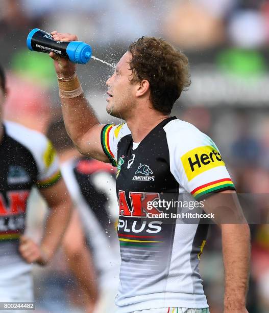 Matthew Moylan of the Panthers sprays water in his face during the round 16 NRL match between the North Queensland Cowboys and the Penrith Panthers...