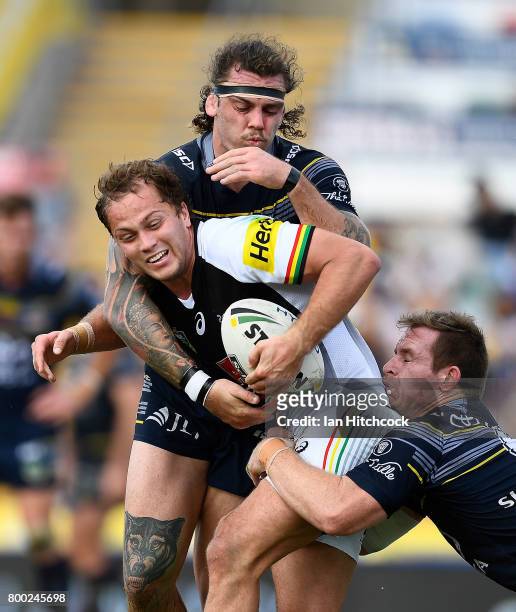 Matthew Moylan of the Panthers is tackled by Michael Morgan and Ethan Lowe of the Cowboys during the round 16 NRL match between the North Queensland...