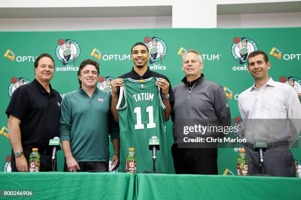 Jayson Tatum of the Boston Celtics holds his jersey as he poses for a picture with Wyc Grousbeck, Stephen Pagliuca, Brad Stevens and Danny Ainge of...