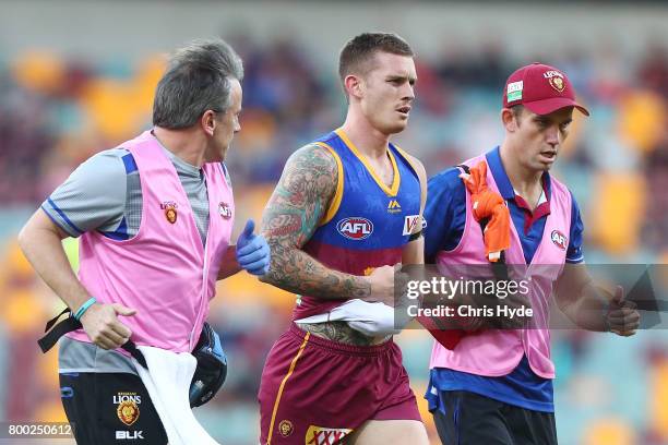 Dayne Beams of the Lions leaves the field injured during the round 14 AFL match between the Brisbane Lions and the Greater Western Sydney Giants at...