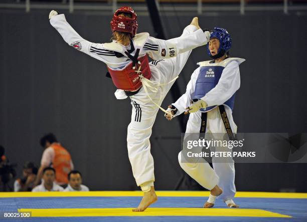 Lei Jie of China avoids a kick from Maeva Musso of France in the women's 57kg catagory in the Good Luck Beijing 2008 International Taekwondo...