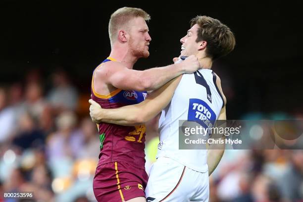 Nick Robertson of the Lions and Toby Greene of the Giants grapple during the round 14 AFL match between the Brisbane Lions and the Greater Western...