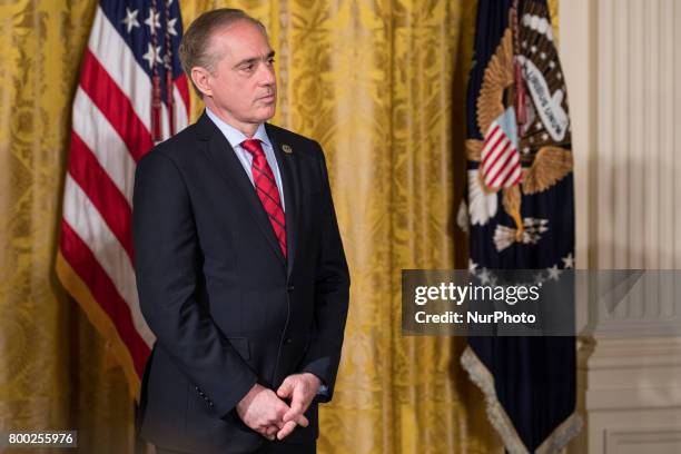 Secretary David Shulkin listens, as President Donald Trump speaks, before signing the Department of Veterans Affairs Accountability and Whistleblower...