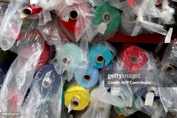 Picture taken on June 21, 2017 shows textiles rolls at the sewing studio of the production plant of the French sport clothing and equipment brand Le...