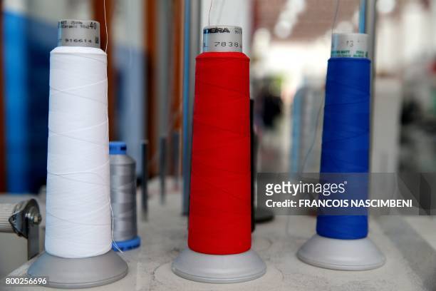 Picture taken on June 21, 2017 shows threads rolls at the sewing studio of the production plant of the French sport clothing and equipment brand Le...