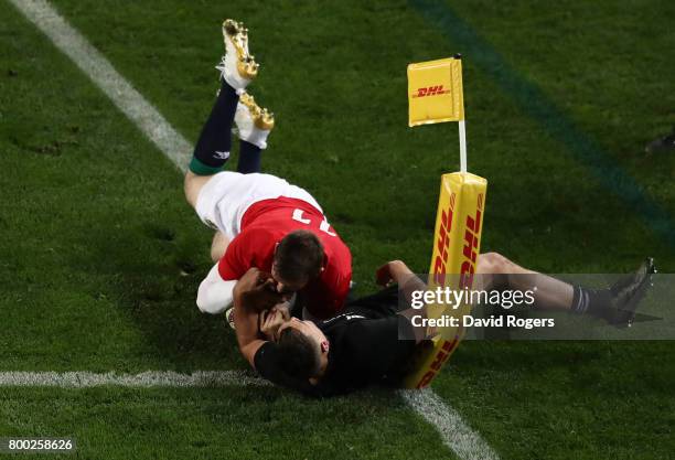 Elliot Daly of the Lions is tackled short of the tryline by Israel Dagg of the All Blacks during the first test match between the New Zealand All...