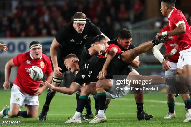 All Black Israel Dagg passes in the tackle with support from Brodie Retallick during the Test match between the New Zealand All Blacks and the...