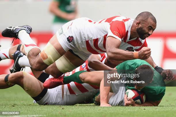 John Cooney of Ireland is tackled by Michael Leitch of Japan during the international rugby friendly match between Japan and Ireland at Ajinomoto...