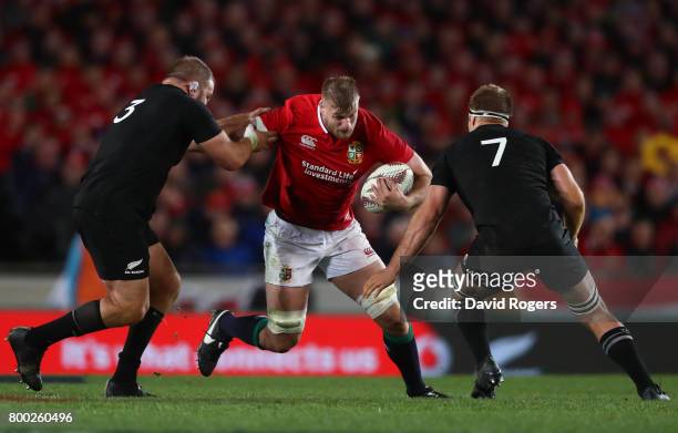 George Kruis of the Lions is tackled by Owen Franks and Sam Cane of the All Blacks during the first test match between the New Zealand All Blacks and...