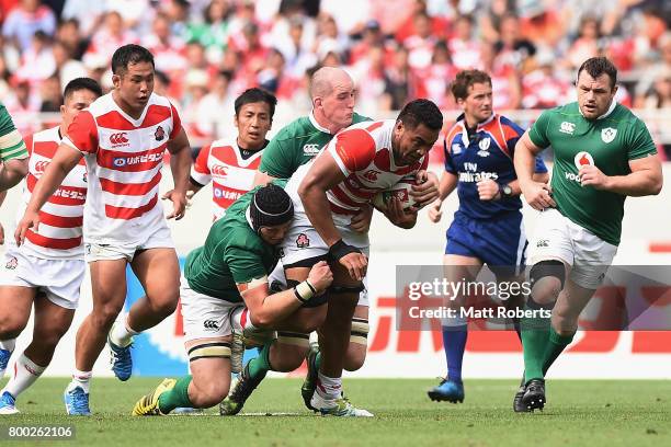 Uwe Helu of Japan is tackled during the international rugby friendly match between Japan and Ireland at Ajinomoto Stadium on June 24, 2017 in Tokyo,...