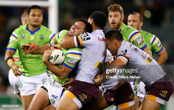 Jordan Rapana of the Raiders is tackled high during the round 16 NRL match between the Canberra Raiders and the Brisbane Broncos at GIO Stadium on...