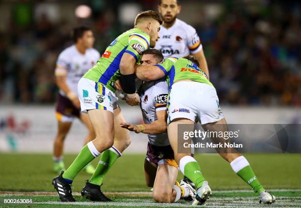 James Roberts of the Broncos is tackled during the round 16 NRL match between the Canberra Raiders and the Brisbane Broncos at GIO Stadium on June...