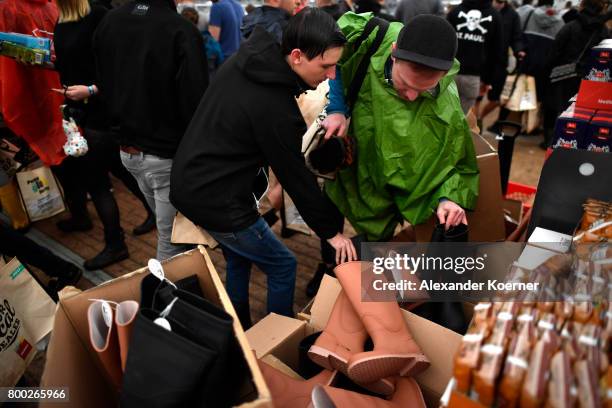 Festival goer shop for welly boots inside an makeshift supermarket at the camp site of the Hurricane Festival 2017 after a night full of heavy rain...