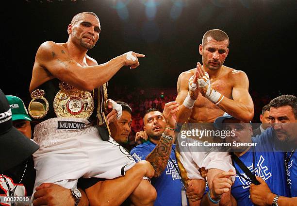 Anthony Mundine of Australia pays respect to Nader Hamdan of Australia after winning their WBA super-middleweight title fight and retaining his world...