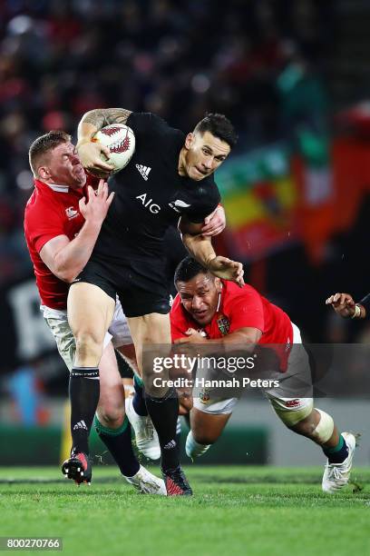 Sonny Bill Williams of the All Blacks shrugs off the tackles from Tadhg Furlong and Mako Vunipola of the Lions during the first test match between...