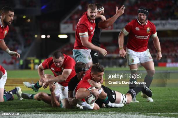 Rhys Webb of the Lions barges past Scott Barrett of the All Blacks to score his team's second try during the first test match between the New Zealand...