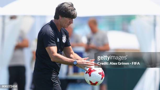 Head coach Joachim Loew of Germany holds a ball during a Germany training session ahead of their FIFA Confederations Cup Russia 2017 Group B match...
