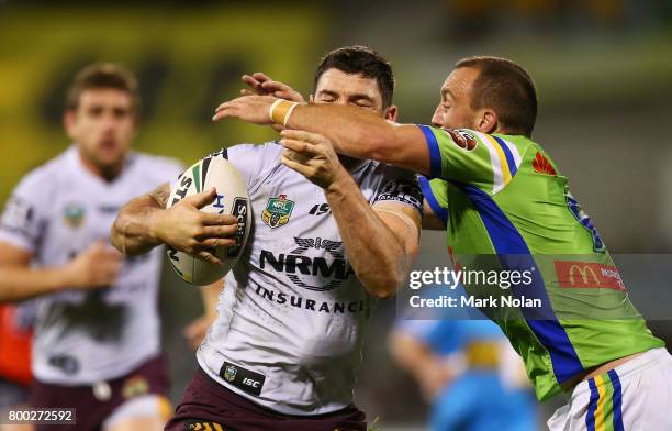 Matt Gillett of the Broncos is tackled during the round 16 NRL match between the Canberra Raiders and the Brisbane Broncos at GIO Stadium on June 24,...