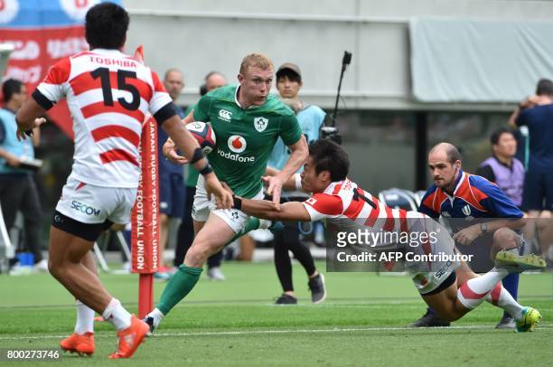 Ireland's fullback Andrew Conway runs away past Japan's left-wing Kenki Fukuoka during their rugby union Test match in Tokyo on June 24, 2017. / AFP...