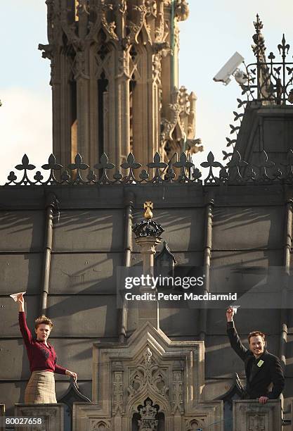 Protestors wave paper aeroplanes as they occupy the roof of Parliament on February 27, 2008 in London. The demonstrators from action group 'Plane...