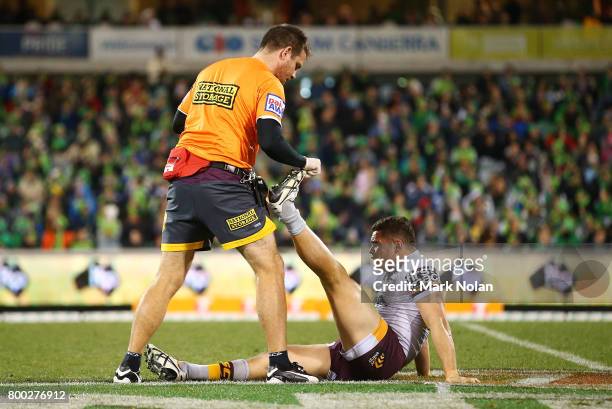 James Roberts of the Broncos receives attention during the round 16 NRL match between the Canberra Raiders and the Brisbane Broncos at GIO Stadium on...