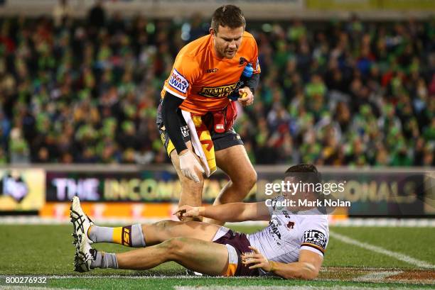 James Roberts of the Broncos receives attention during the round 16 NRL match between the Canberra Raiders and the Brisbane Broncos at GIO Stadium on...