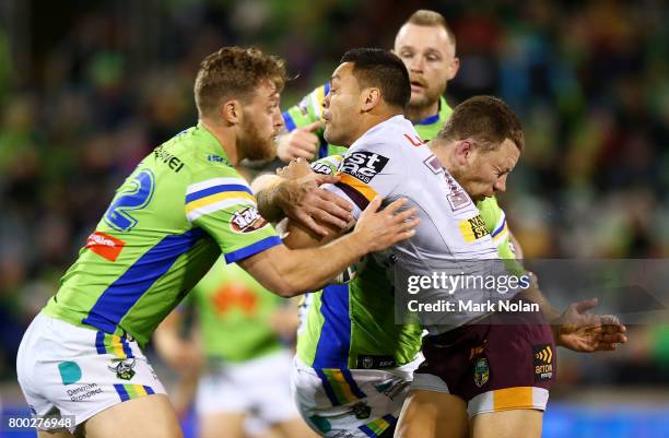 Alexander Glenn of the Broncos is tackled during the round 16 NRL match between the Canberra Raiders and the Brisbane Broncos at GIO Stadium on June...