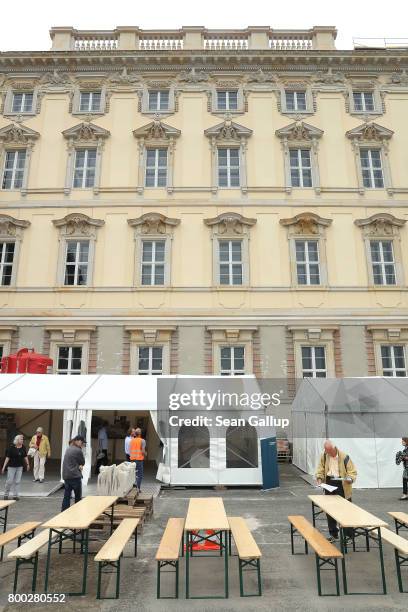 Visitos walk among tents outside a finished facade during open house day at the construction site of the Berlin City Palace, which will house the...