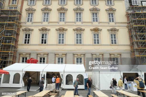 Visitos walk among tents outside a finished facade during open house day at the construction site of the Berlin City Palace, which will house the...