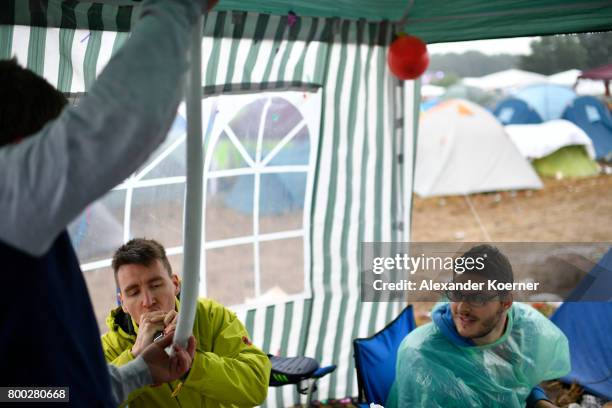 Festival goer drinks a beer at the camp site of the Hurricane Festival 2017 after a night full of heavy rain and winds on June 24, 2017 in Scheessel,...