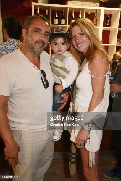 Actor Jean Pierre Martins, his baby and Alexandra Genoves attend La Fete des Tuileries on June 23, 2017 in Paris, France.