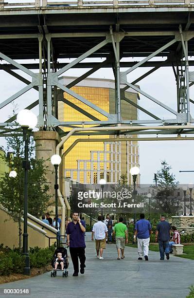 Patrons of the new Louisiana Boardwalk in Bossier City, opened only a month earlier, enjoy an early summer evening overlooking the Red River. The...