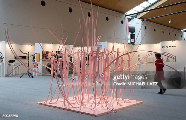 Woman walks past the sculpture "Der Verletzlichkeit Raum geben" by Swiss artist Shang Hutteron February 27, 2008 in Karlsruhe, during the...