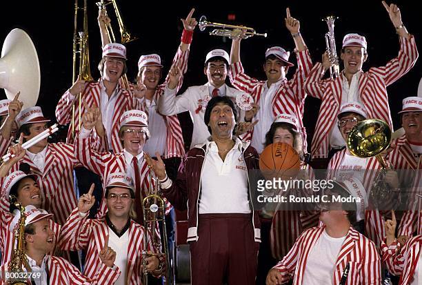 Coach Jim Valvano of North Carolina State poses with band members in November 1983 in Raleigh, North Carolina.