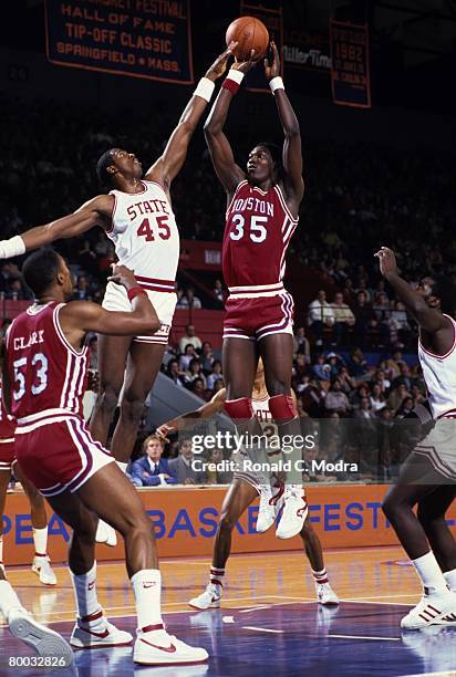 Akeem Olajuwon of the Houston Cougars takes the shot against the North Carolina State Wolfpack on November 19, 1983 in Raleigh, North Carolina.