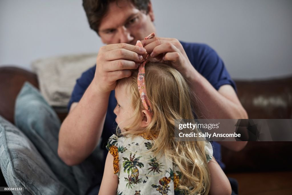 Father styling child hair