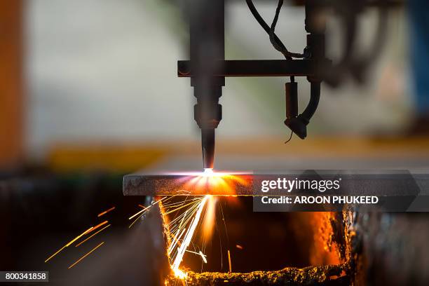 plasma cutting process of metal material with sparks - laser cutting stock pictures, royalty-free photos & images