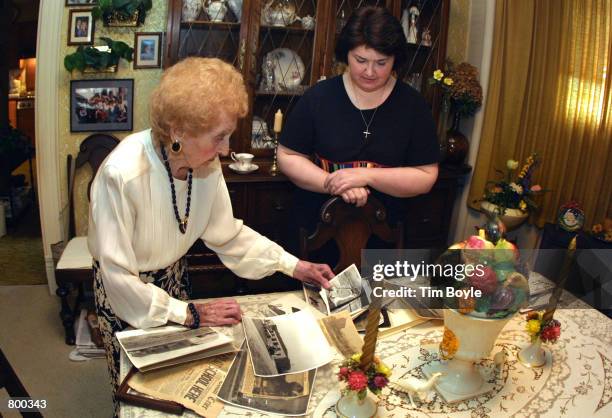 Emma Schweer along with her care-giver Wendy A. Daly, LPN, right, peruse through some old photographs and newspaper clippings April 10, 2001 in...