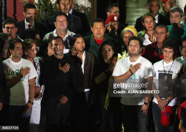 Venezuelan president Hugo Chavez sings the national anthem accompanied by the Colombian hostages released by the FARC, at the Miraflores presidential...